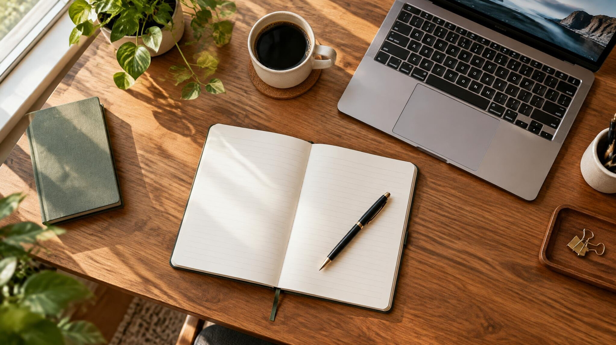 Notebook and laptop on a desk for writing